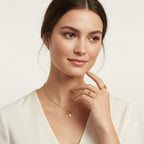 Seraphina Treasures Emberlyn necklace with a single pearl pendant on a gold chain, worn by a model.