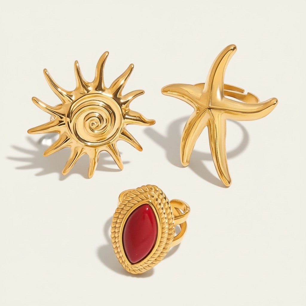 Seraphina Treasures Ephyra Rings: gold starfish, sun, and red oval stone rings. Adjustable metal.