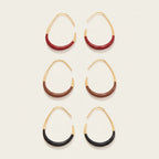 Seraphina Treasures Eudynelle gold hoop earrings with red, brown, and black enamel drip detail.