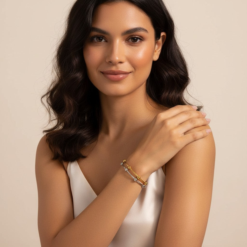 Seraphina Treasures Evadne bracelet with gold and silver tones, featuring a slim, open design with small decorative beads.
