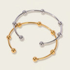 Seraphina Treasures Evadne open cuff bracelet with gold and silver finishes, featuring small decorative beads.