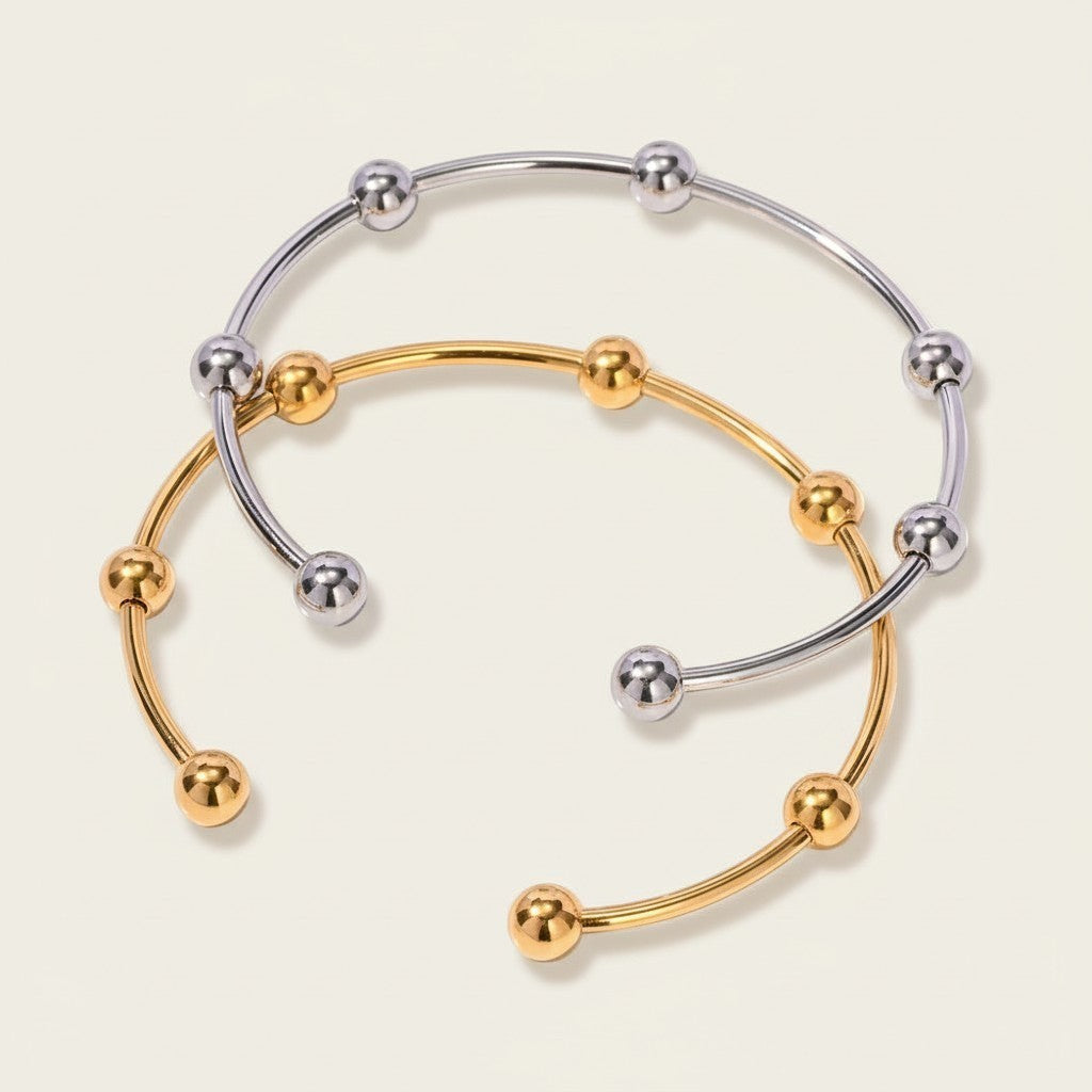 Seraphina Treasures Evadne open cuff bracelet with gold and silver finishes, featuring small decorative beads.