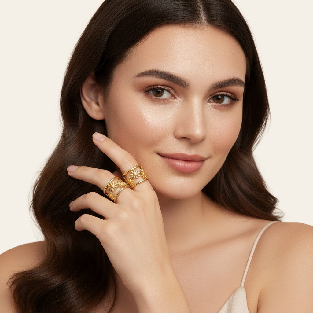 Seraphina Treasures Gaia rings: two adjustable metal rings with daisy flower cutouts, one gold-tone, one silver-tone.