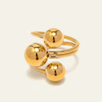 Seraphina Treasures gold-tone open ring with three polished ball accents, modern design.