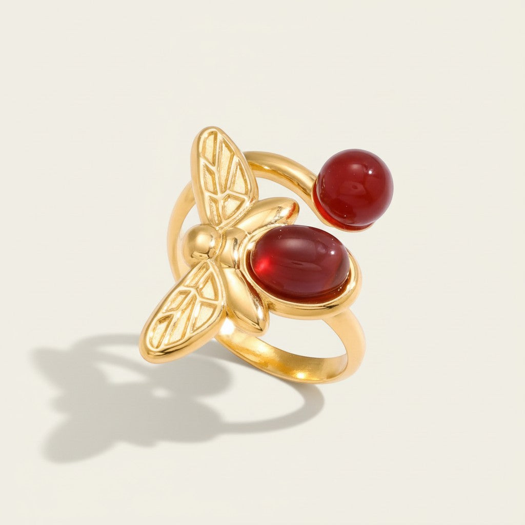 Seraphina Treasures gold bee ring with red agate gemstones. Open design, adjustable fit.