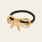 Seraphina Treasures gold bow hair tie accessory with black elastic band.