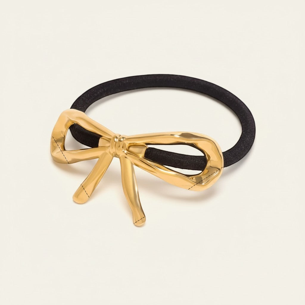 Seraphina Treasures gold bow hair tie accessory with black elastic band.
