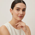 Seraphina Treasures gold-tone bow and heart pendant earrings, delicate and charming.