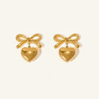 Seraphina Treasures gold-tone metal bow earrings with dangling heart pendants.