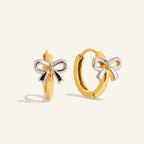 Seraphina Treasures gold hoop earrings with a two-tone silver and gold bow charm. Perfect for adding a playful touch.