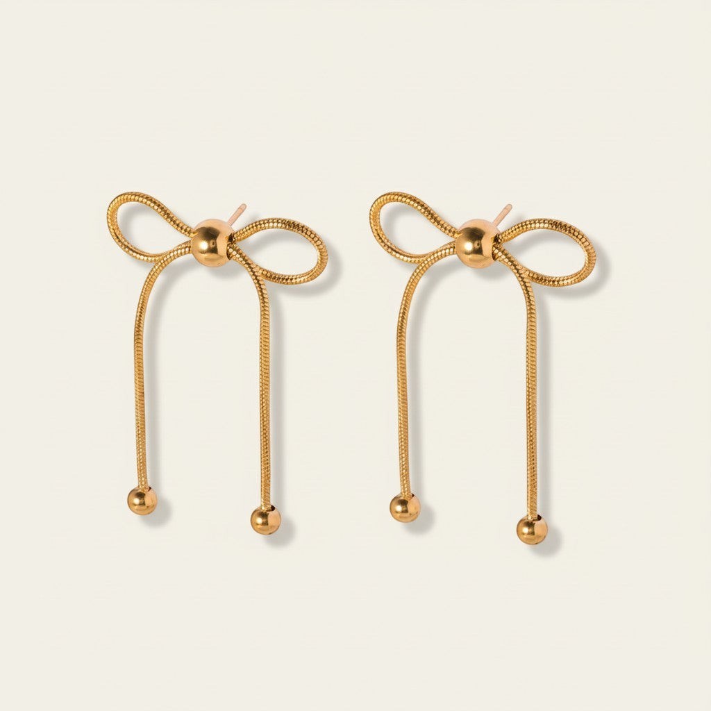 Seraphina Treasures gold bow drop earrings with bead details. Elegant and delicate design.