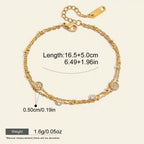 Seraphina Treasures gold-tone two-tier bracelet with beaded chains and clear crystal charms. Adjustable length.