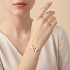 Seraphina Treasures gold-tone bracelet with three white shell butterfly charms, adjustable chain.