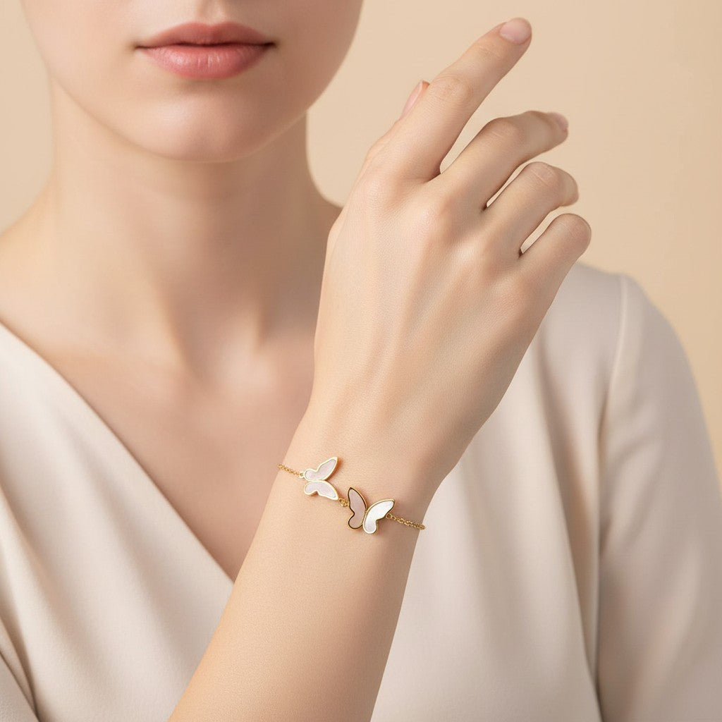 Seraphina Treasures gold-tone bracelet with three white shell butterfly charms, adjustable chain.