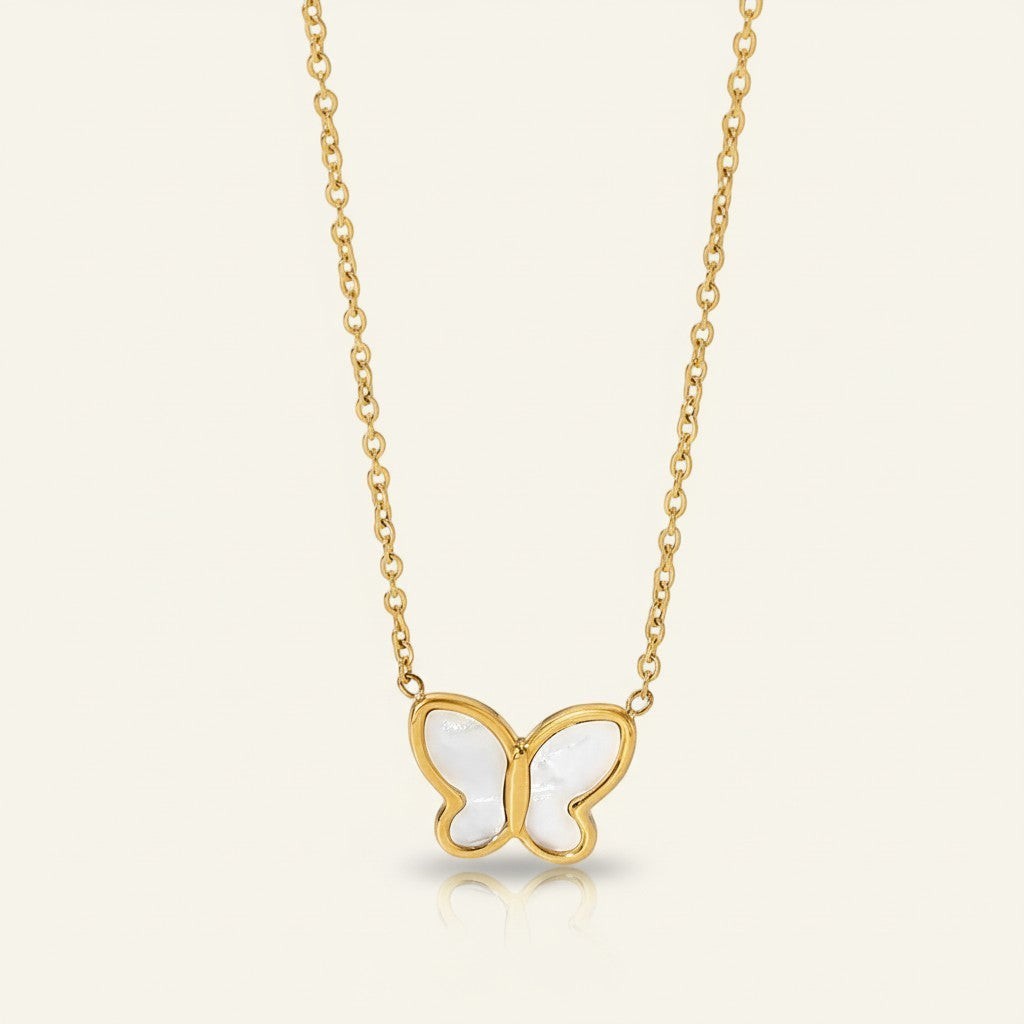 Seraphina Treasures gold necklace with a white mother-of-pearl butterfly pendant, symbolizing transformation.