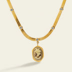 Seraphina Treasures gold snake chain necklace with cameo pendant and zirconia accents.