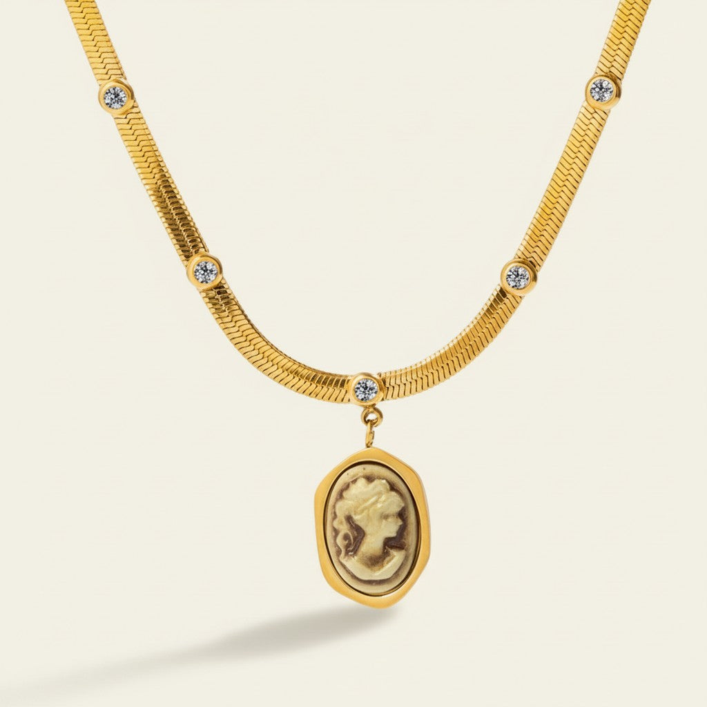 Seraphina Treasures gold snake chain necklace with cameo pendant and zirconia accents.