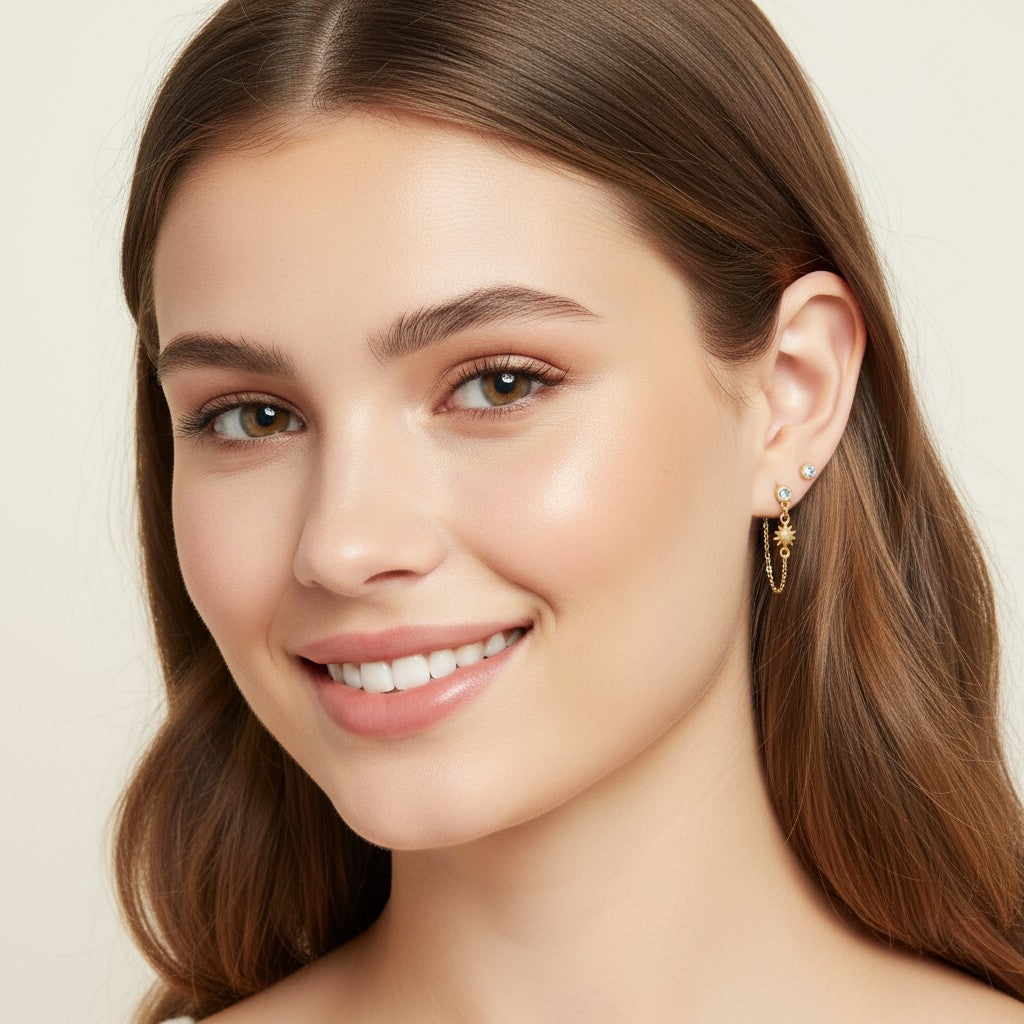 Seraphina Treasures gold celestial sun and moon drop earrings with a small clear gem stud.