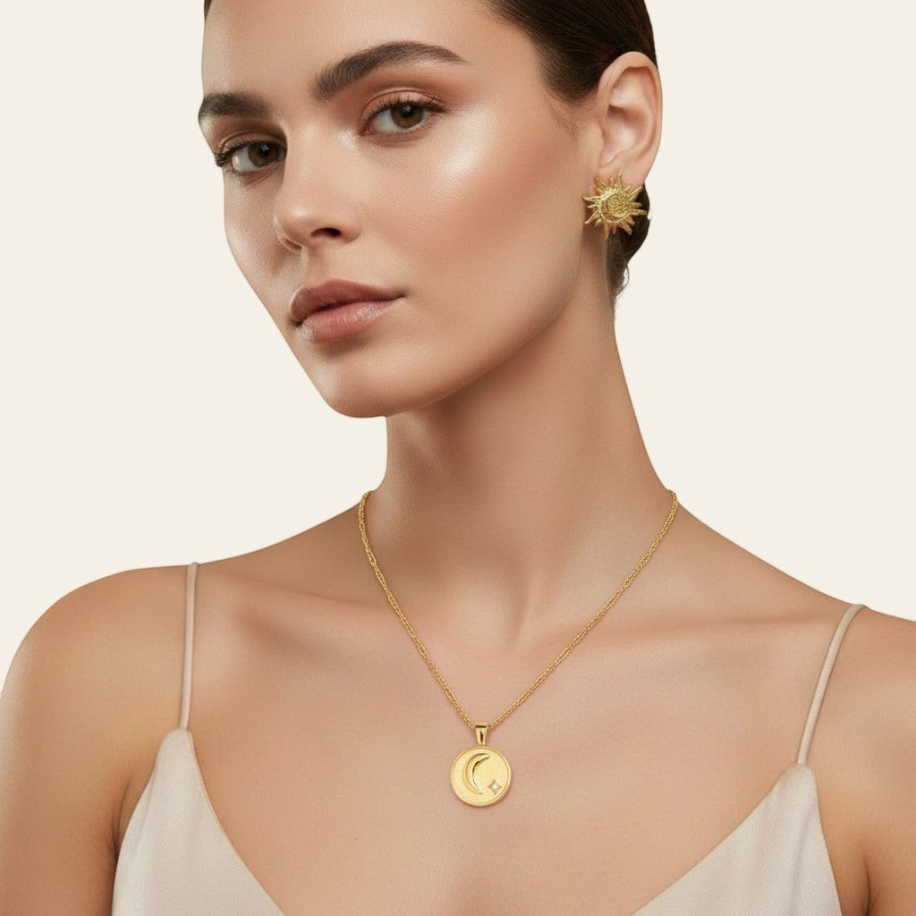 Seraphina Treasures gold necklace with reversible moon and star or sun pendant, featuring celestial designs and a crystal accent.