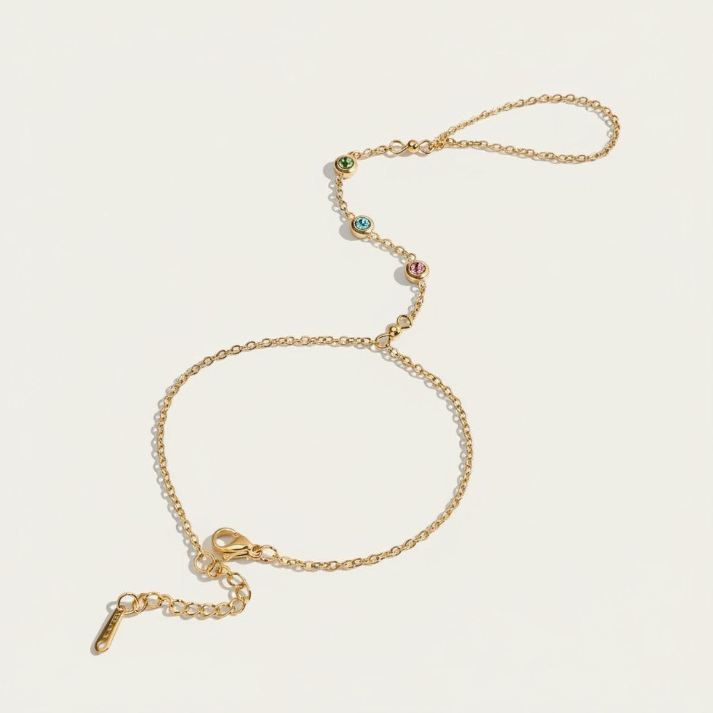 Seraphina Treasures gold chain bracelet and ring set with green, blue, and pink cubic zirconia stones.