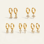 Seraphina Treasures gold hoop earrings with cubic zirconia cherry, star, bear, cross, and dog charms.