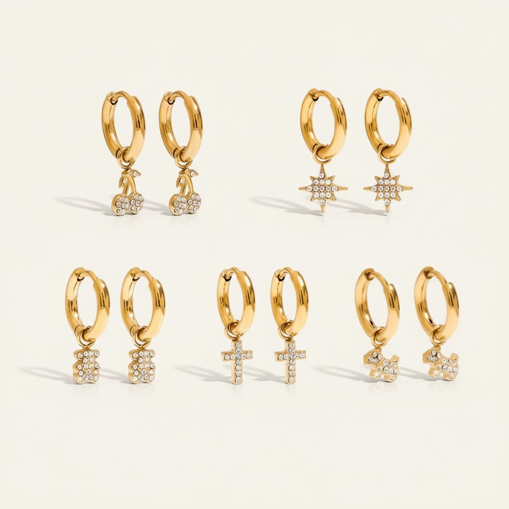 Seraphina Treasures gold hoop earrings with cubic zirconia cherry, star, bear, cross, and dog charms.