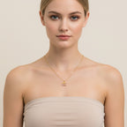 Seraphina Treasures gold necklace with a cherry pendant adorned with pink zirconia stones and delicate leaf details.
