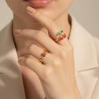 Seraphina Treasures gold-tone open ring with cherry design and red enamel details. Adjustable size.
