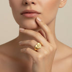 Seraphina Treasures gold heart ring with an embossed cherub design. Symbolizes love and protection.