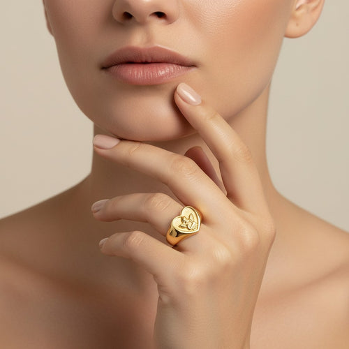 Seraphina Treasures gold heart ring with an embossed cherub design. Symbolizes love and protection.