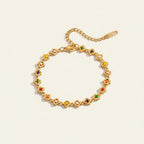 Seraphina Treasures gold-tone bracelet with clover-shaped links and colorful enamel accents.