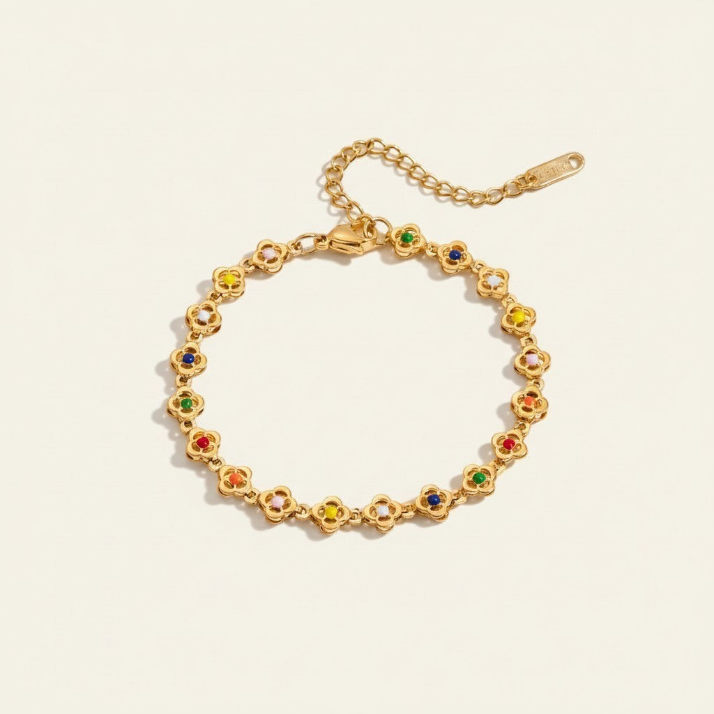 Seraphina Treasures gold-tone bracelet with clover-shaped links and colorful enamel accents.