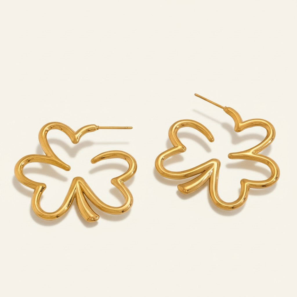 Seraphina Treasures gold clover-shaped hoop earrings with intricate botanical design.