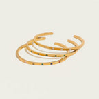 Seraphina Treasures gold-tone cuff bracelets with colorful zircon stones and clear crystals, adjustable open design.