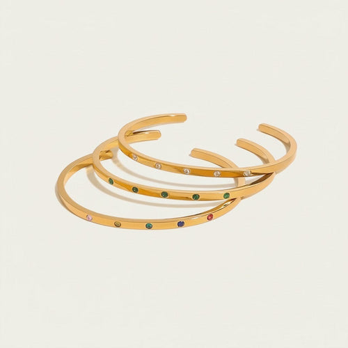 Seraphina Treasures gold-tone cuff bracelets with colorful zircon stones and clear crystals, adjustable open design.