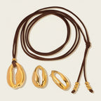 Seraphina Treasures gold cowrie shell necklace with brown cord and matching earrings.