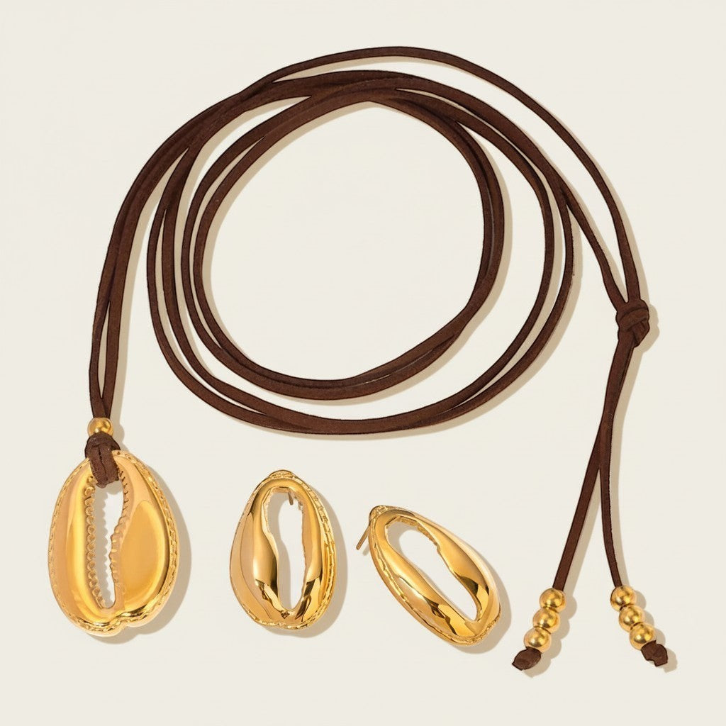 Seraphina Treasures gold cowrie shell necklace with brown cord and matching earrings.