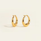 Seraphina Treasures gold crescent hoop earrings with a minimalist, celestial-inspired design.