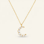 Seraphina Treasures gold-tone necklace with a crescent moon pendant adorned with clear brilliant-cut stones.