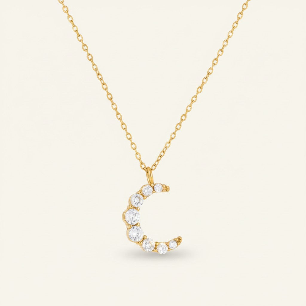 Seraphina Treasures gold-tone necklace with a crescent moon pendant adorned with clear brilliant-cut stones.