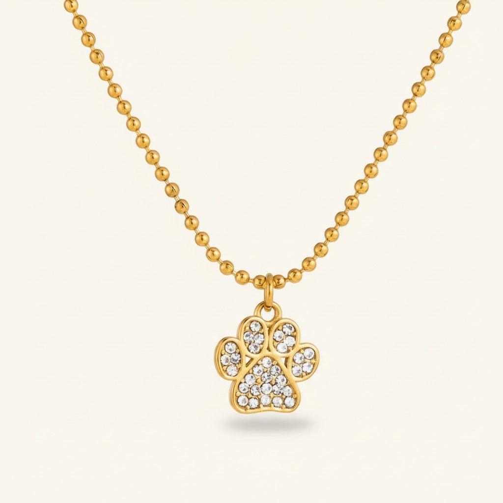 Seraphina Treasures gold-tone necklace with a crystal-encrusted cat paw pendant on a beaded chain.