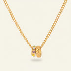 Seraphina Treasures gold necklace with two interlocking pendants, one with multi-colored crystals.
