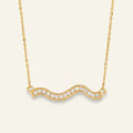 Seraphina Treasures gold wave necklace with clear crystals. Elegant and versatile.