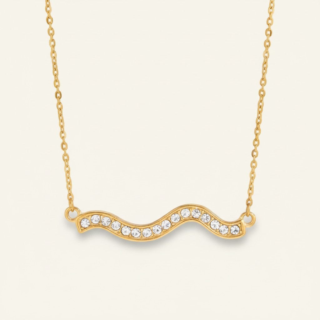 Seraphina Treasures gold wave necklace with clear crystals. Elegant and versatile.