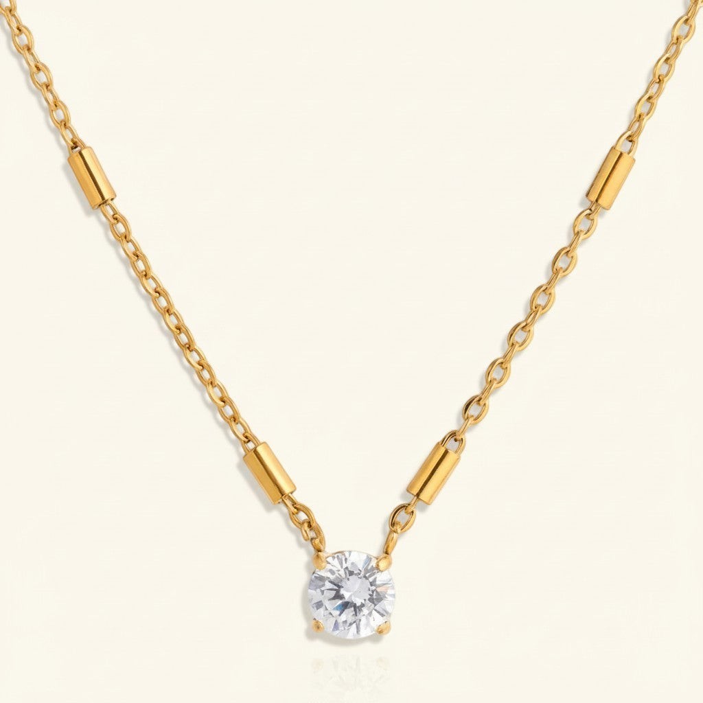 Seraphina Treasures Elarion gold necklace with cubic zirconia pendant and minimalist bar details on chain.