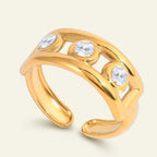Seraphina Treasures gold open band ring with three cubic zirconia stones and hollow design.