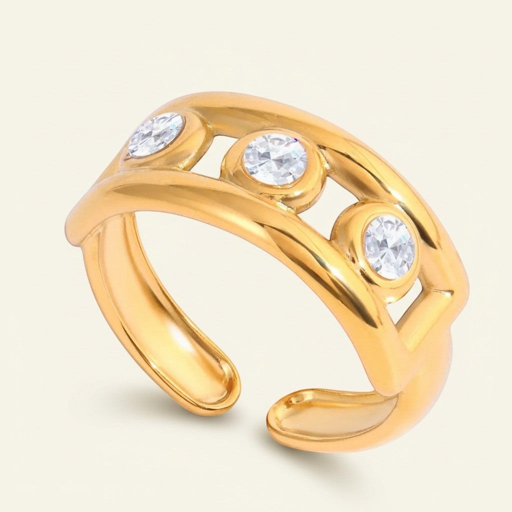 Seraphina Treasures gold open band ring with three cubic zirconia stones and hollow design.