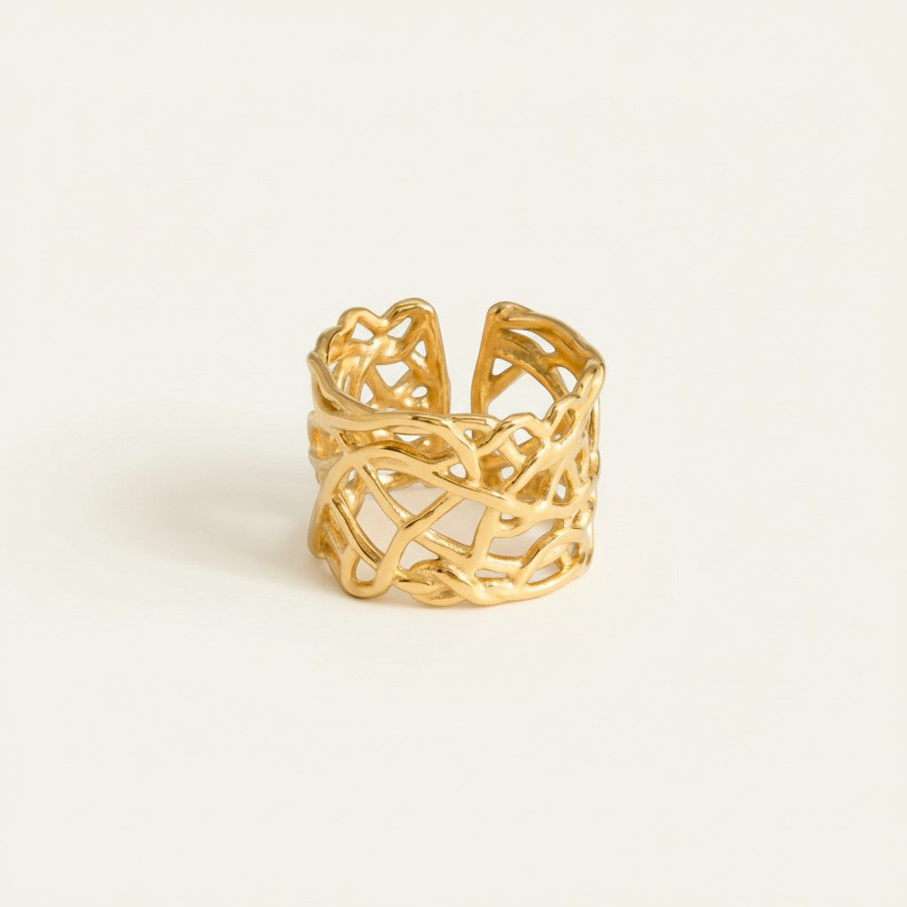 Seraphina Treasures gold cutout geometric ring with open band construction and angular patterns.