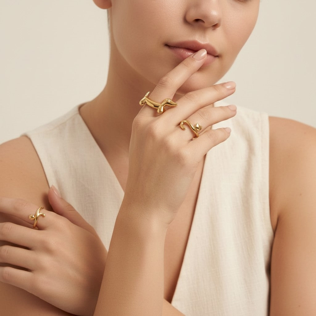 Seraphina Treasures gold dachshund ring with zirconia eye and gold cat ring on a woman's hand.