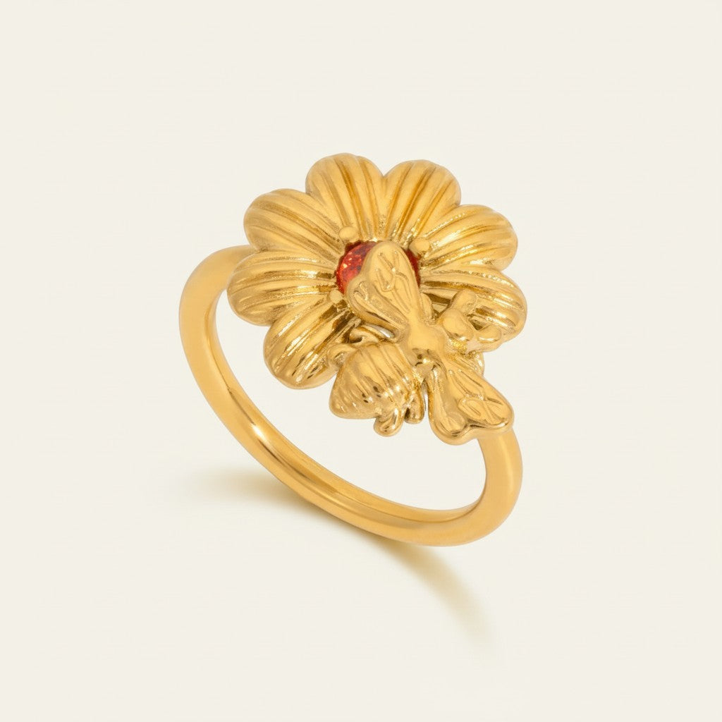 Seraphina Treasures gold-tone open band ring with a daisy design and a bee accent, featuring a red gemstone center.